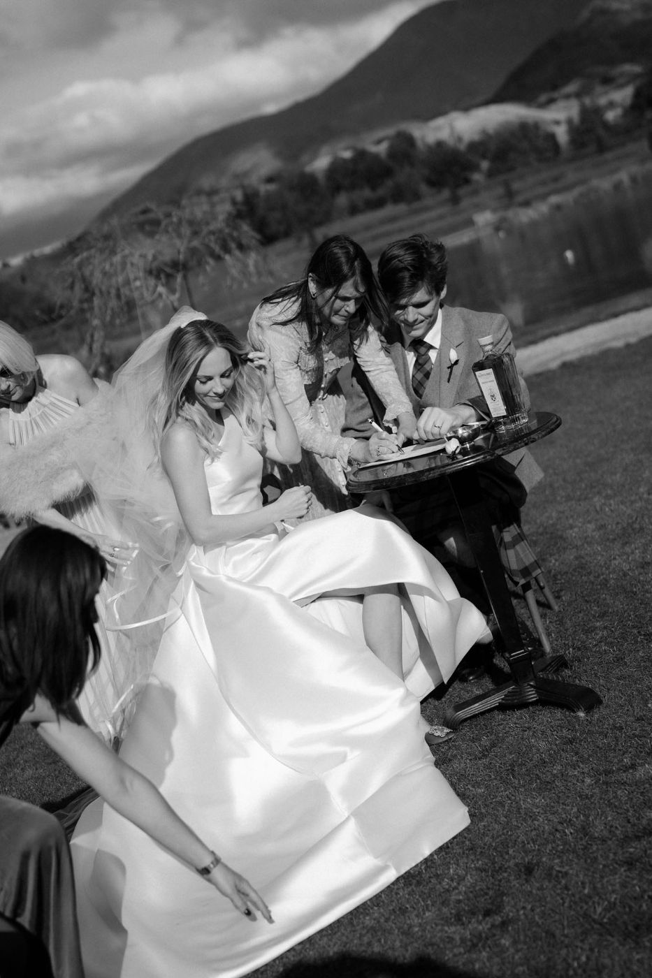 Bride laughing with guests on a hillside in Queenstown