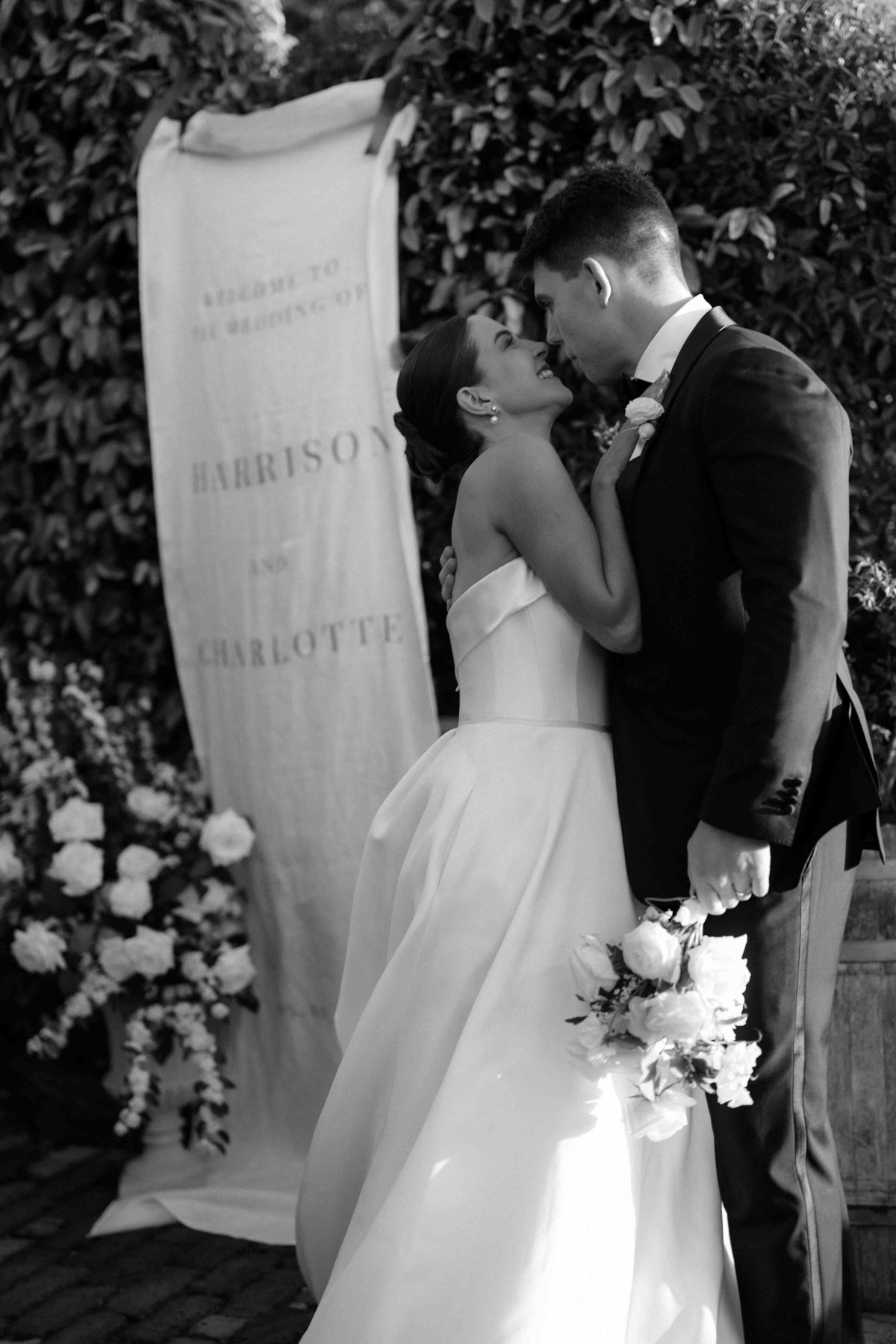 First kiss in front of a welcome sign
