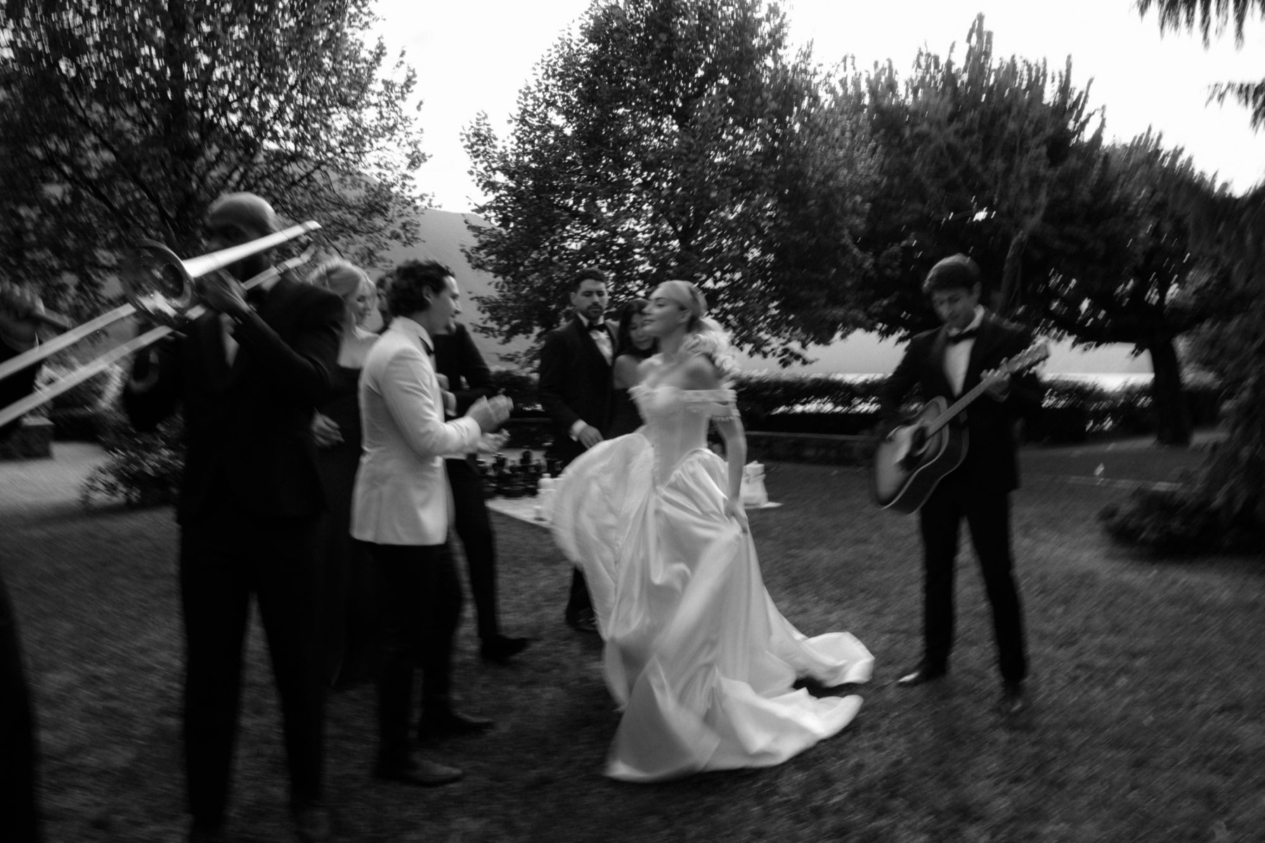 Bride dancing with a brass band in a Lake Como garden
