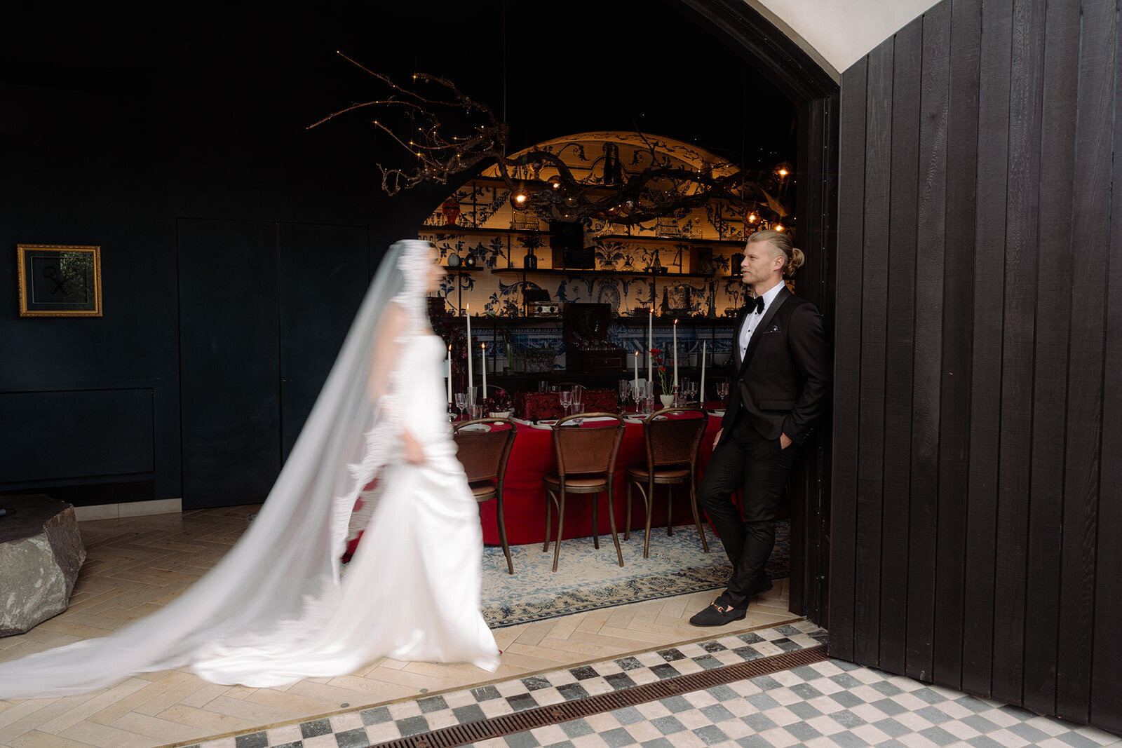 Bride walking towards her groom through a restaurant doorway