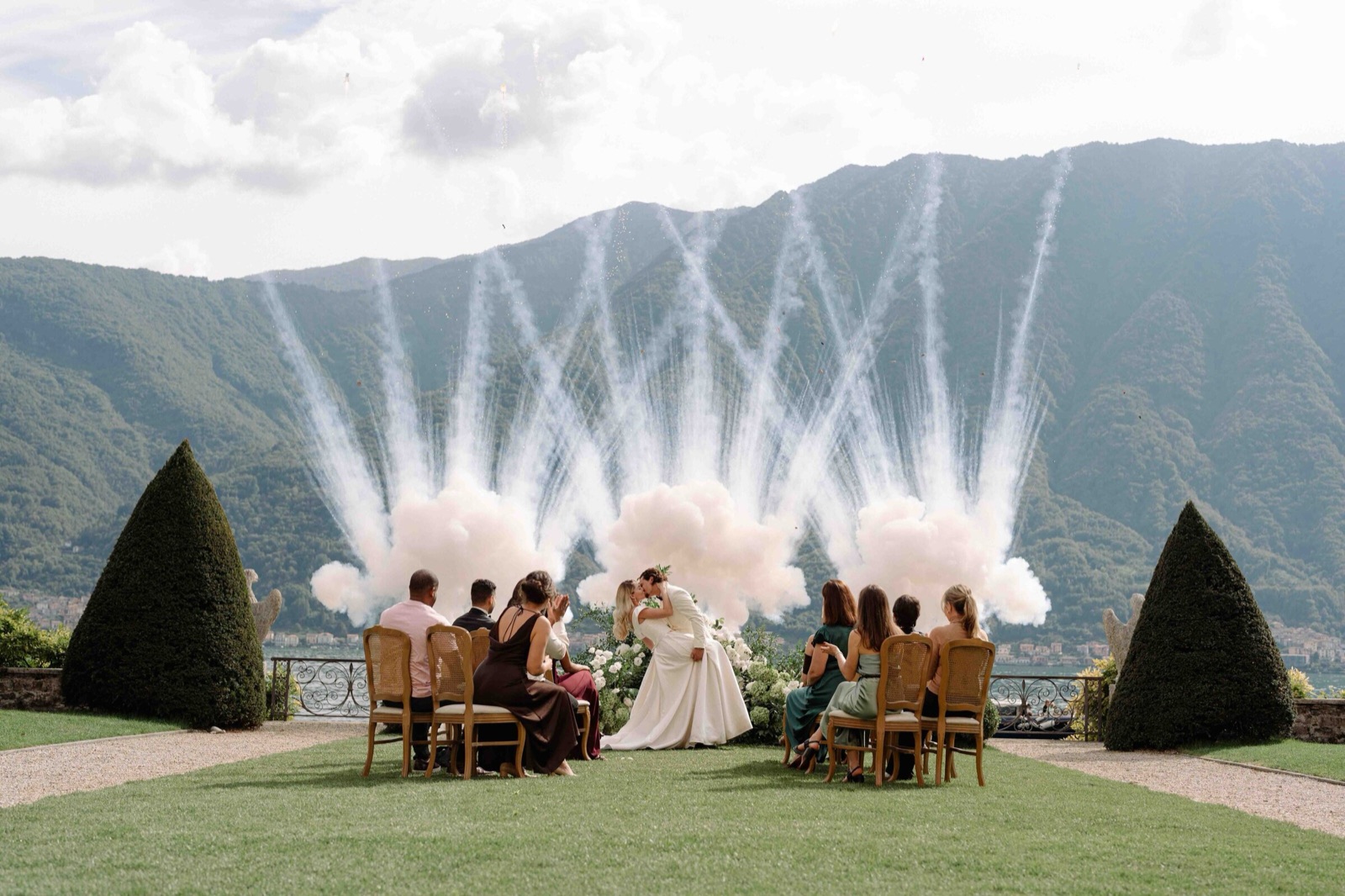 Lakeside ceremony with cold sparklers behind the couple