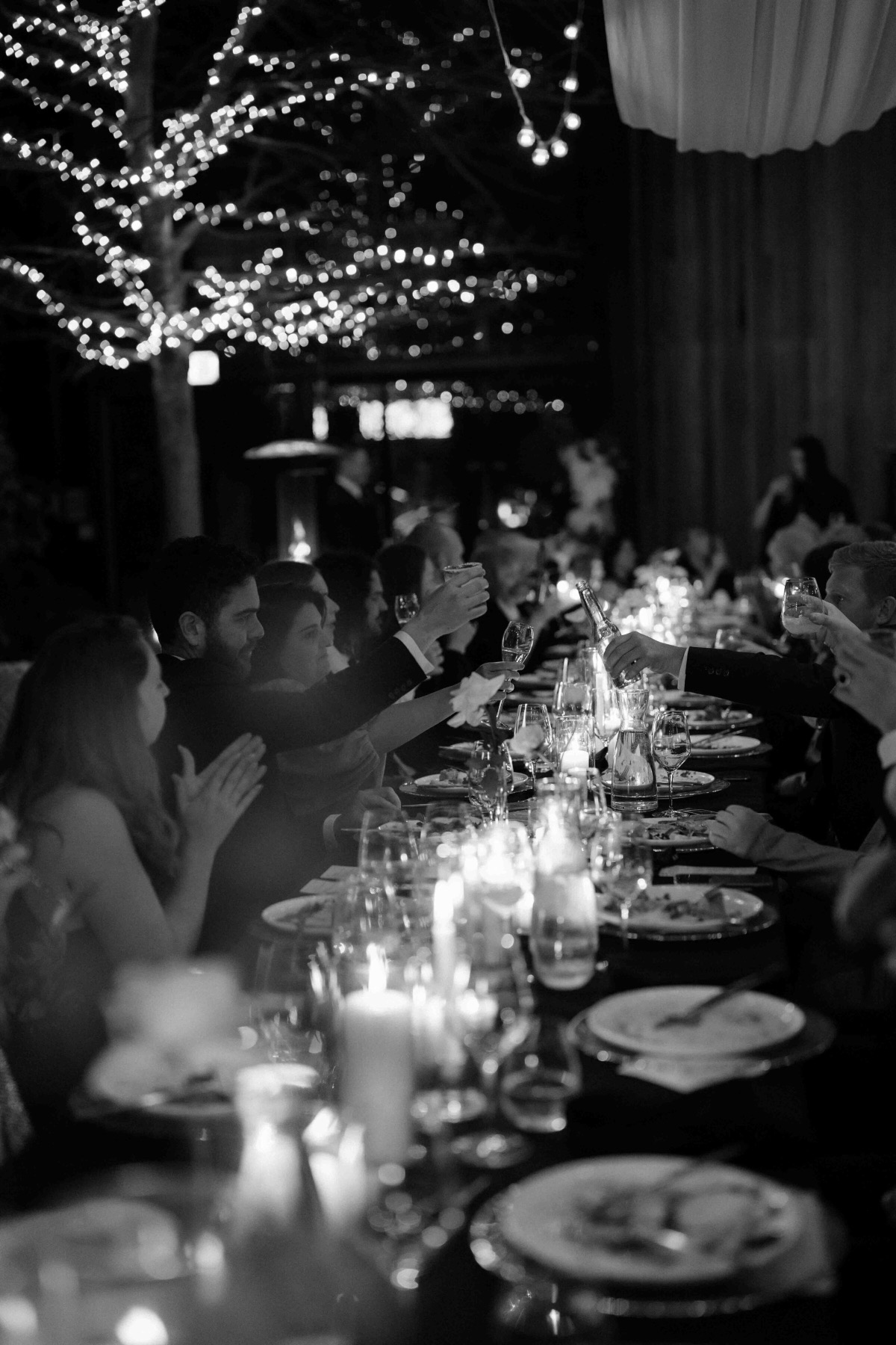Candlelit reception table under fairy lights