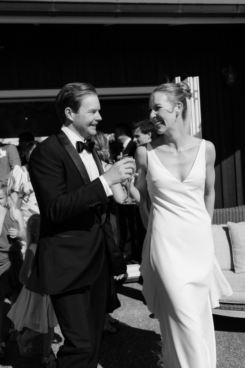 Couple laughing together with a drink